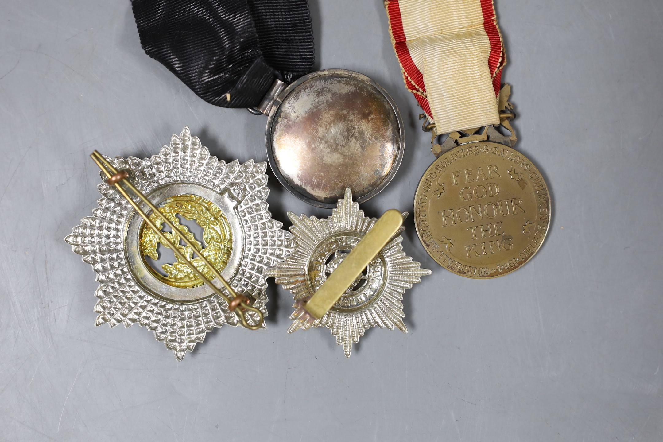 An Edwardian ‘Fear God Honour the King’ medal, ‘The Cheshire Regiment’ badge, and two other medals and badge (4)